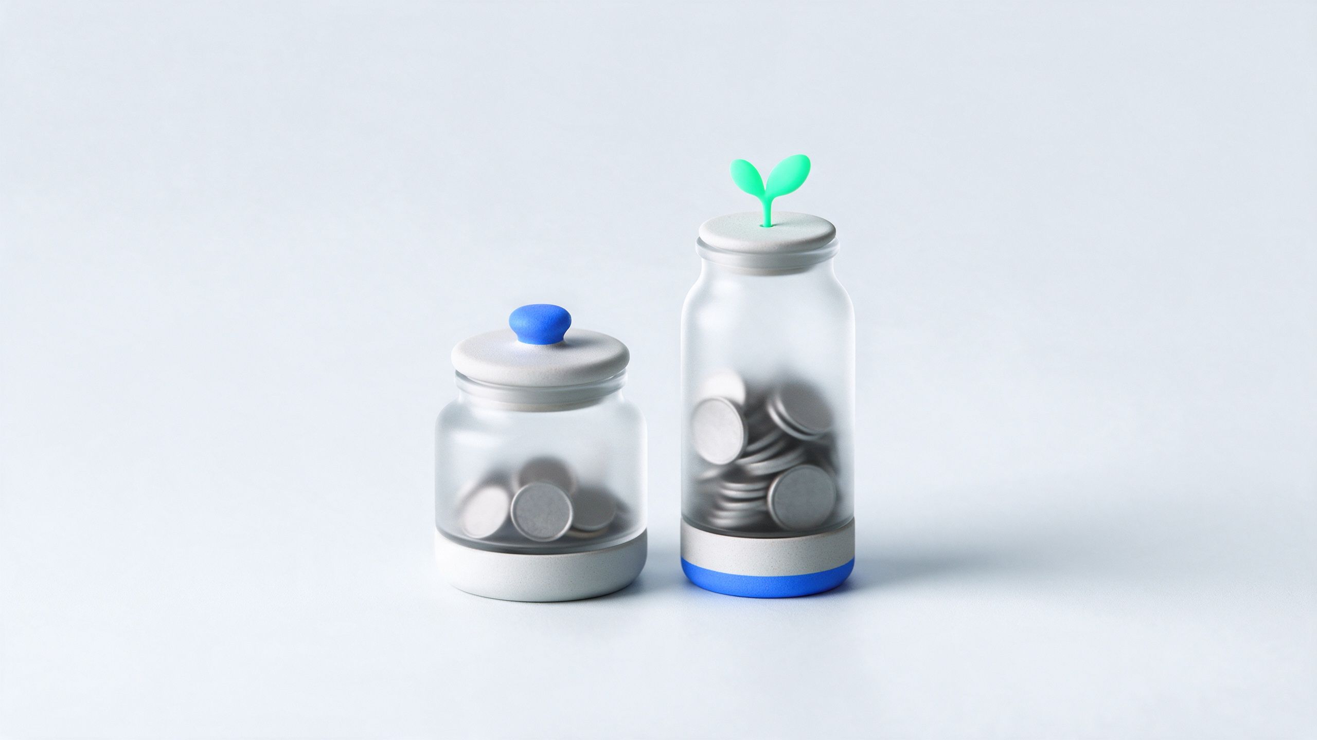 Two glass savings jars, one short and one tall with a small plant growing from it