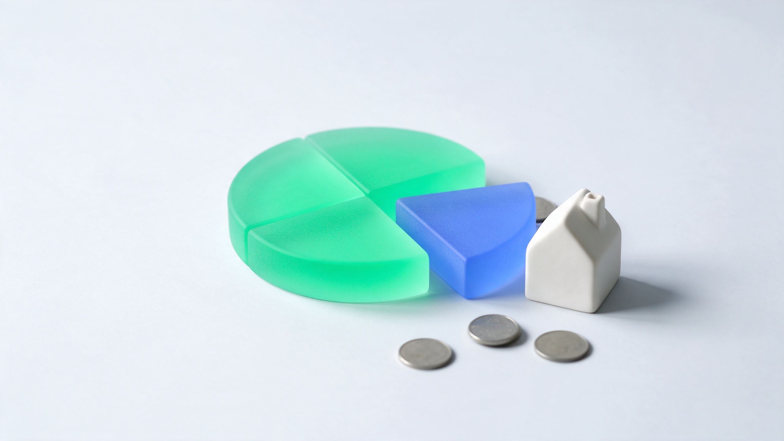 A model house next to a round disc with one quarter pulled away