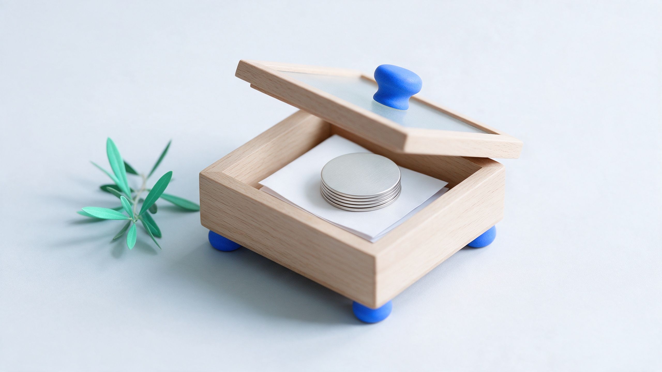 An open wooden keepsake box holding a folded letter and a few coins